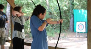 camper shooting bow and arrow