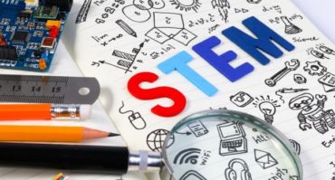 STEM written on paper with pens and pencils
