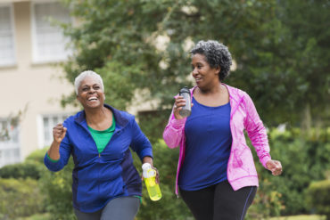 Two senior African American women getting in shape together.