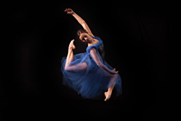 Dancer in midair in blue dress