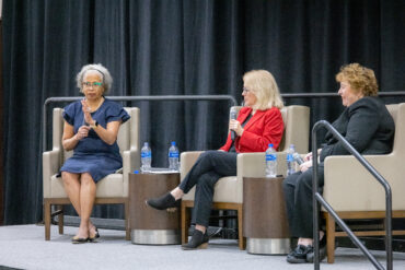 Drs. Gloria Ladson-Billings, Marilyn Cochran-Smith and Cheryl Craig sit on stage to discuss teacher education in the Zone Club at Kyle Field.