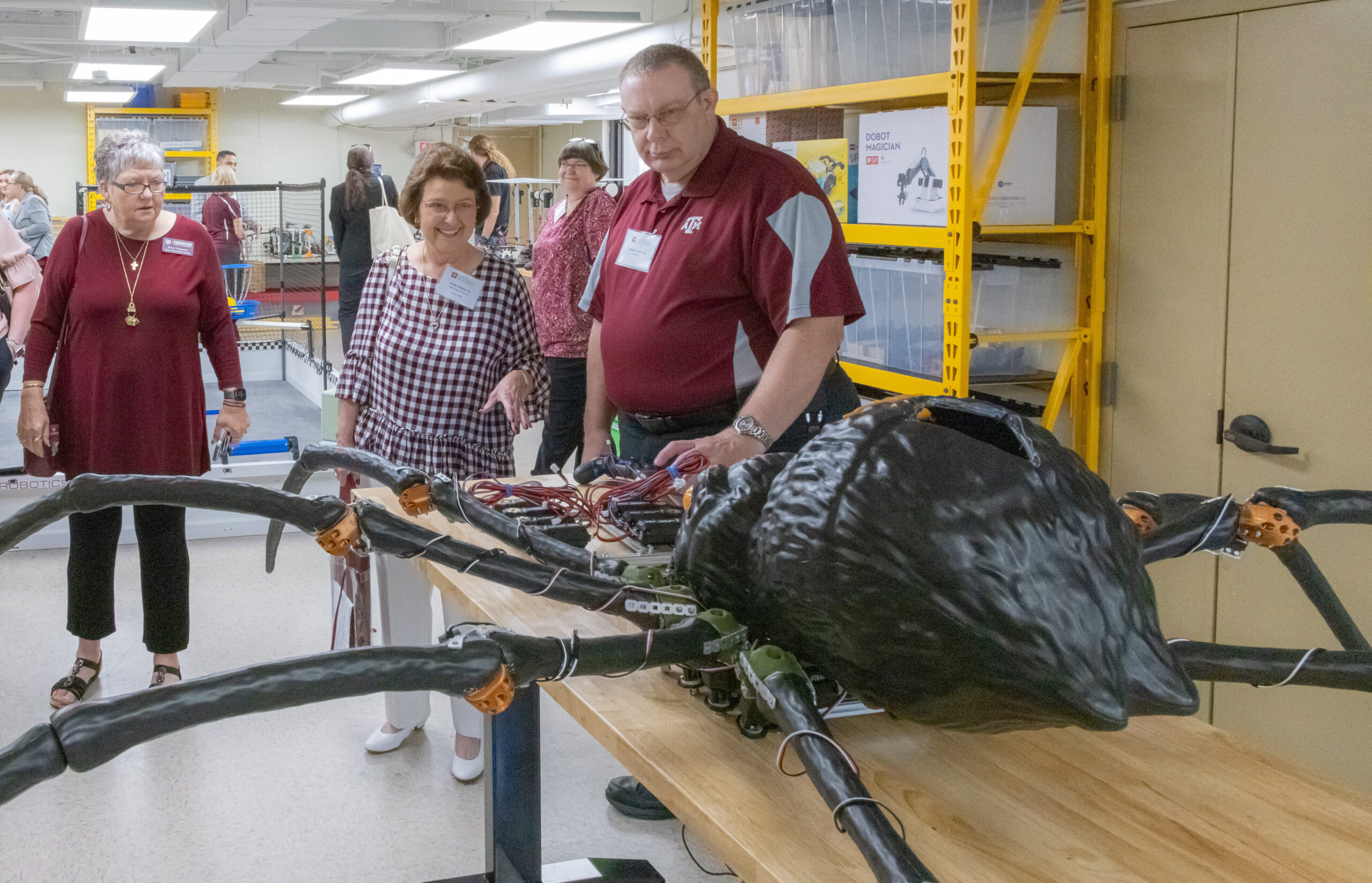 CEHD Dean's Development Council members interact with robotic spider in Dr. Gharib's Cobotics lab.