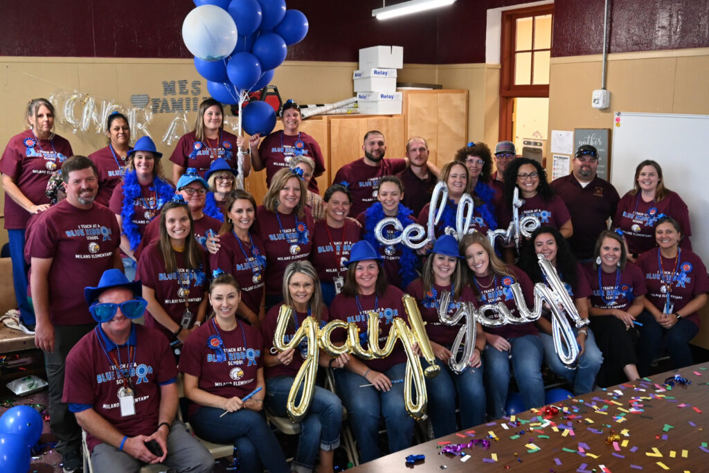 Milano Elementary faculty and staff celebrate being recognized as a National Blue Ribbon school with balloons, signs and other party favors.