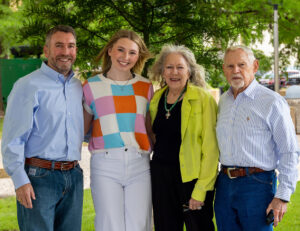 Dailey family poses in front of tree dedicated to Margo Dailey