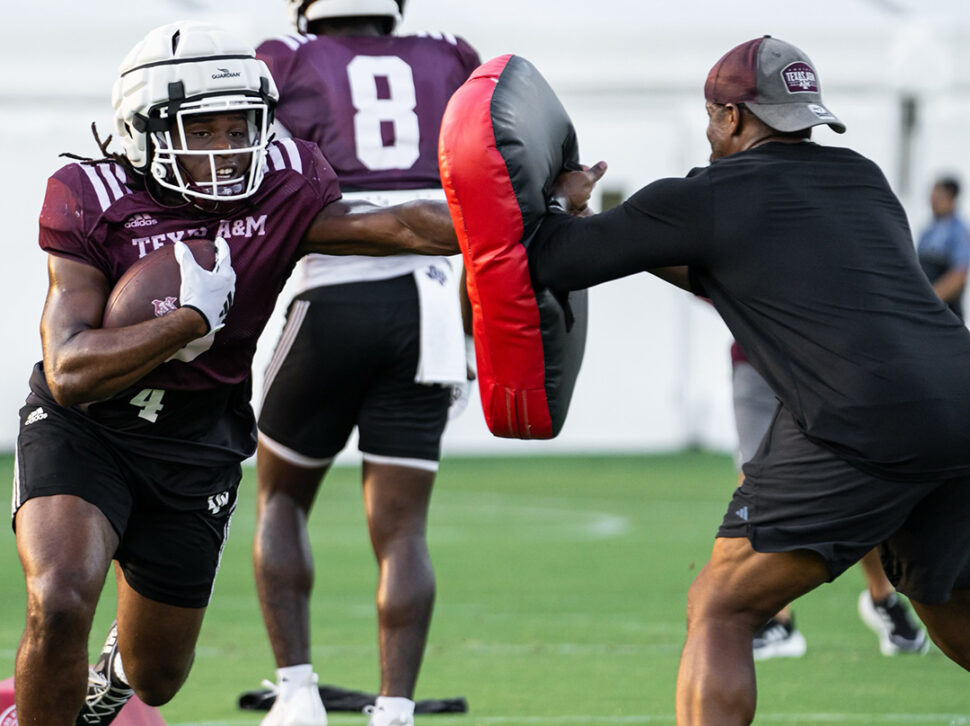 Veteran Coaching Program participant helps with drills during football practice.