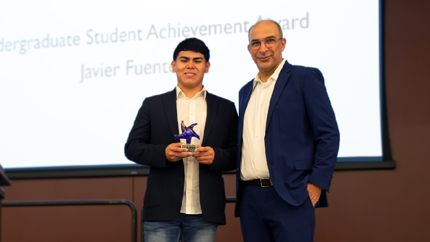 Dr. Khalil Dirani presents Fuentes with his award.