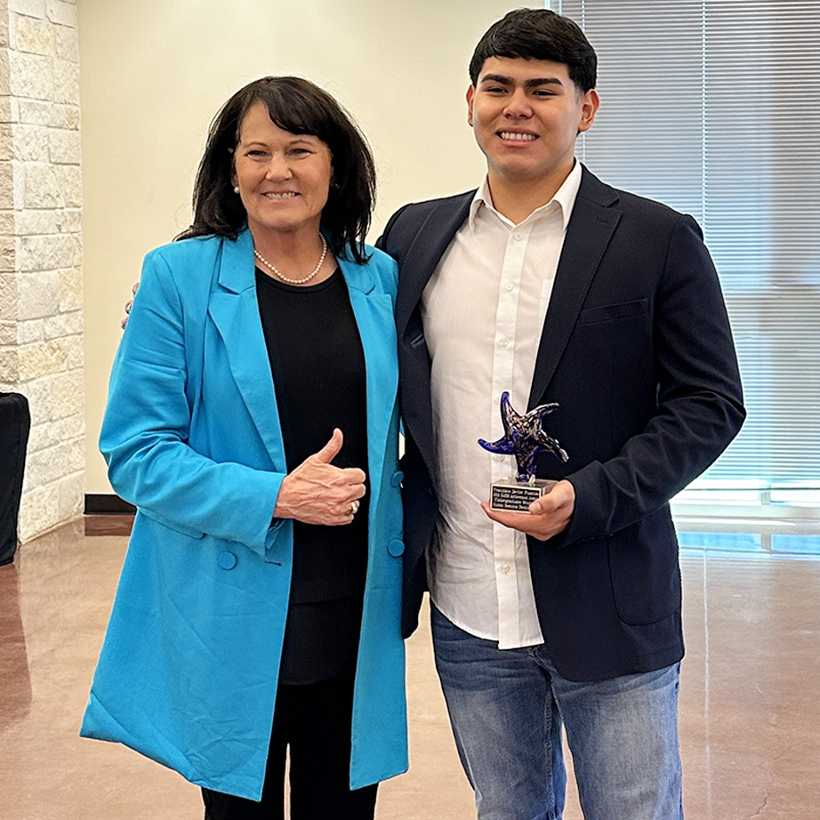 Dr. Paula Yoder celebrates Fuentes' achievement with him.